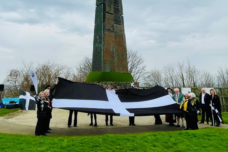 Cornish and Proud.... Saltash residents show off the St Piran's flag in front of the famous Cornish cross