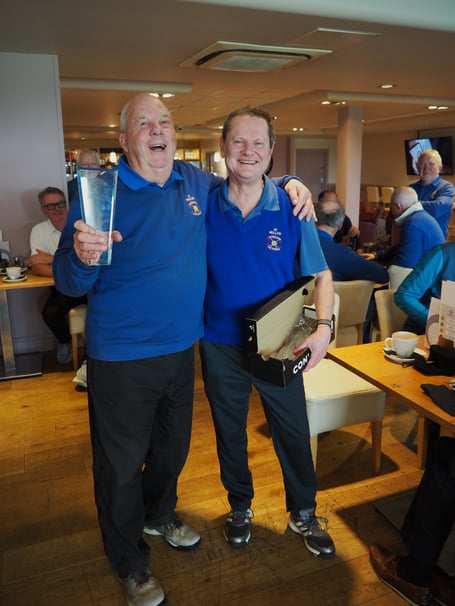 John Clements receives the St Piran's Trophy from Capt. Paul Osborne.