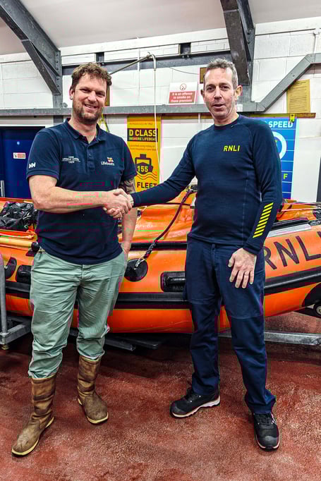 Rich Jones (left) is congratulated by RNLI assessor and trainer Ollie George on passing the final stage of his qualification, taking charge of the station’s D-Class lifeboat Ollie Naismith II (Picture: RNLI/Ian Foster)