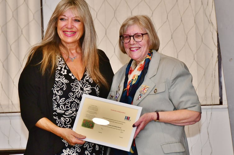 All smiles as the certificate of appreciation is handed over