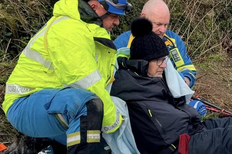 HM Coastguard recuing an orthopaedic surgeon who broke his ankle on a coastal walk. // An orthopaedic surgeon who broke his ankle on a coastal walk had to be rescued by the coastguard. Professor Chris Lavy, an NHS consultant and surgeon, has treated hundreds of of injuries - but unexpectedly became a casualty himself while walking in South Cornwall. Chris, from Oxford, was on a four-day walking trip on the South West coast path with his dog and eight friends. On an overcast day in January, they were walking between the villages of Par and Fowey and despite being well-equipped for wet conditions, the walk took a sudden turn.