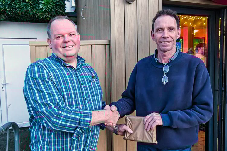 Looe RNLI’s Lifeboat Operations Manager, Clive Palfrey (left) presenting Brian Bowdler with a retirement gift from the crew at Looe Lifeboat Station (Picture: Ian Foster/RNLI)