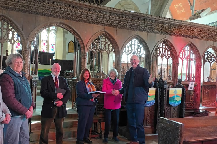 Reverend Richard Allen receives the St Marnarch Church Record on 19 April 2026. Left to right — Church Recorders Frances Impey, John Evans, Anne Rundle and Patricia Francis and the Reverend Richard Allen.