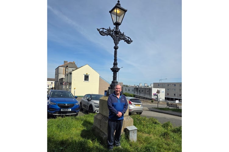 Cllr Rob Parsonage, pictured beneath the historic lantern he has helped save.