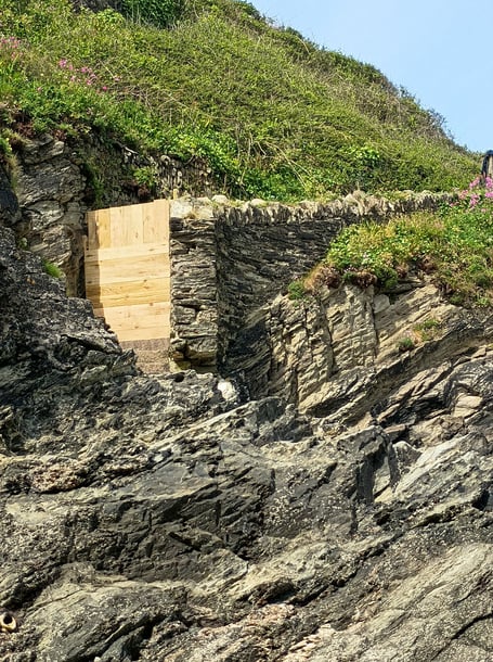 The access to the historic stone steps that descend from the Glendorgal headland down to Porth Beach have been boarded up