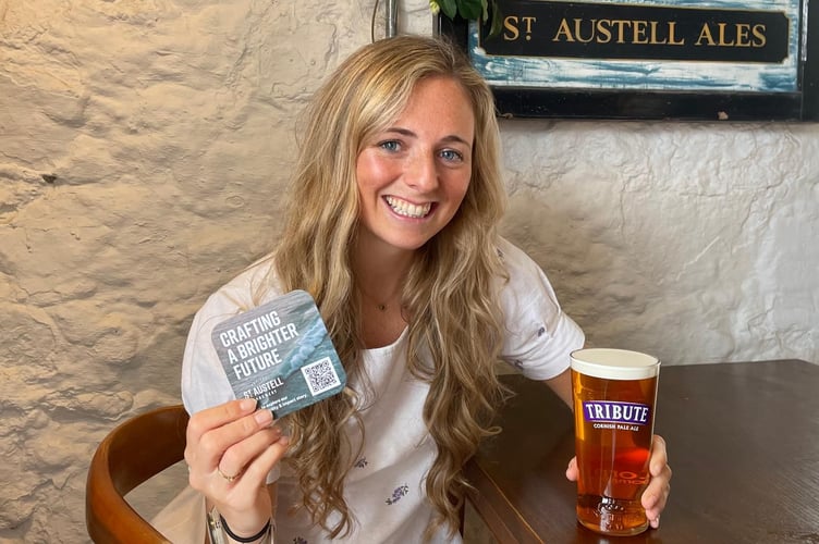 Emily Coon, sustainability manager at St Austell Brewery, with a plantable beer mat.