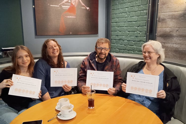St Austell Signing group members with their certificates.