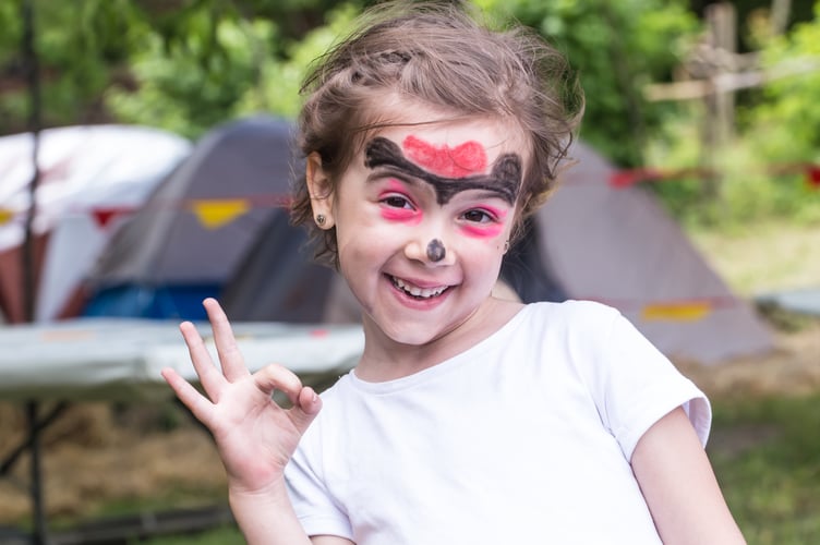 smiling girl with face art painting like tiger, little boy making face painting, halloween party, child with funny face painting, little cute boy with faceart on birthday party close up