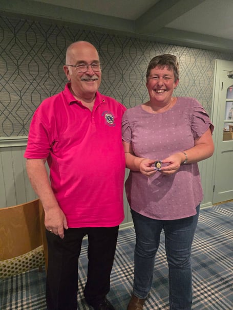 Saltash Tamar Lions Club president John Higgins presents secretary Emma Burnard with the President’s Award in recognition of her dedication and hard work during the club’s inaugural year
