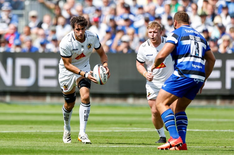Exeter's Andrea Zambonin carries the ball towards the imposing presence of Bath's Thomas du Toit