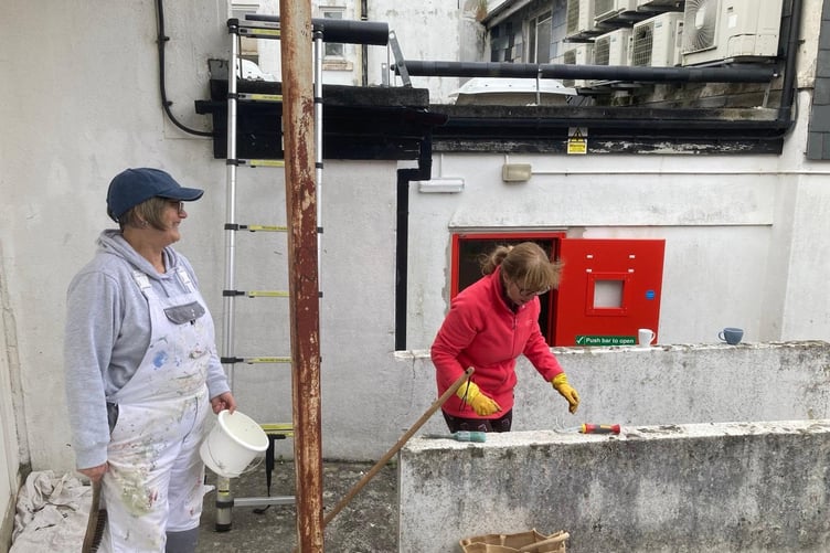 A team of volunteers have recently helped clean graffiti and clear greenery from the rear of the building on Biscombe’s Lane
