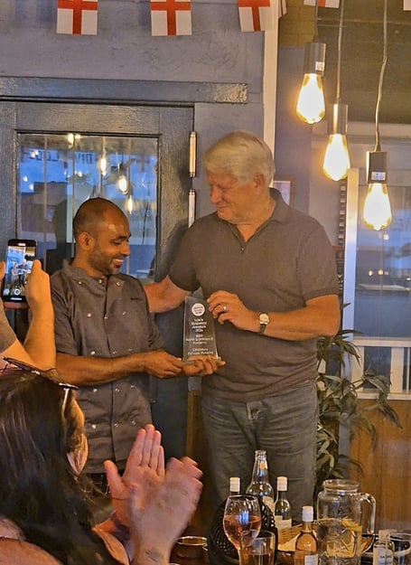 Mansel Ahmed, proprietor of Chennai Indian Fusion, collects his Food & Beverage award from Mike Allsopp