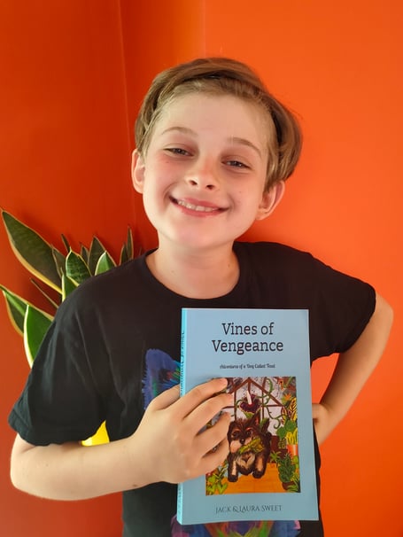 Jack Sweet, 10, is pictured with his first published book 'Vines of Vengeance'