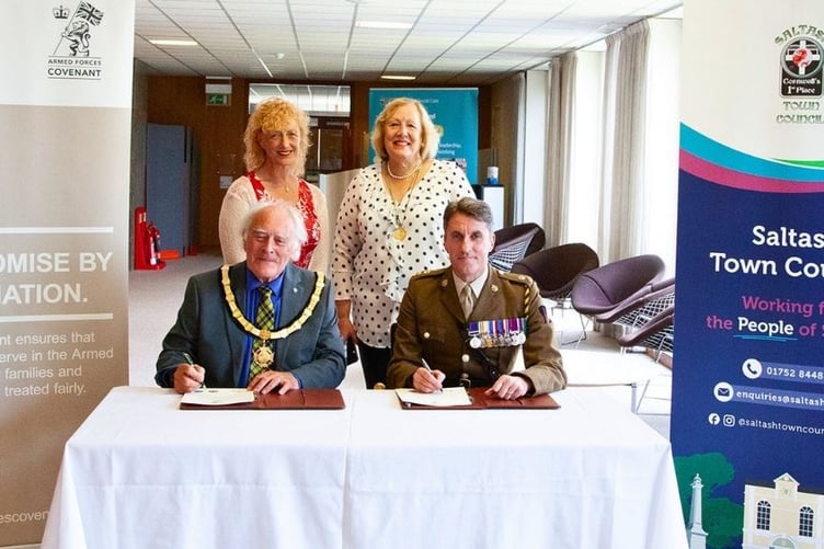 Saltash mayor Cllr Brian Stoyel signs the pledge alongside Lieutenant Colonel John Porter and watched by Cornwall Cllr Hilary Frank and Saltash deputy mayor, Cllr Brenda Samuels