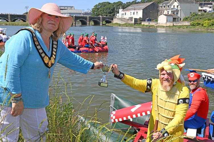 Not content with trying to take Princess Peach from Mario, Bowser seizes the opportunity to swipe the trophy for the long race from Cllr Jules Metcalfe, the mayor of Wadebridge (Picture: Adrian Jasper)