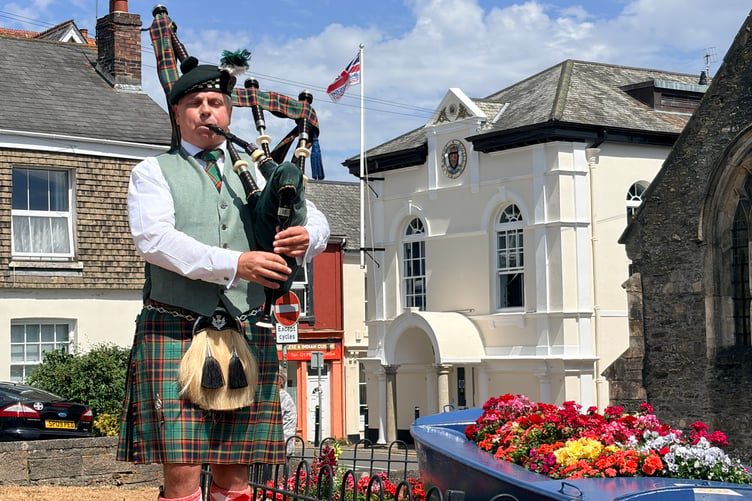 Piper David Parry plays at the Saltash Pebble Memorial Restoration Unveiling Ceremony in Alexandra Square