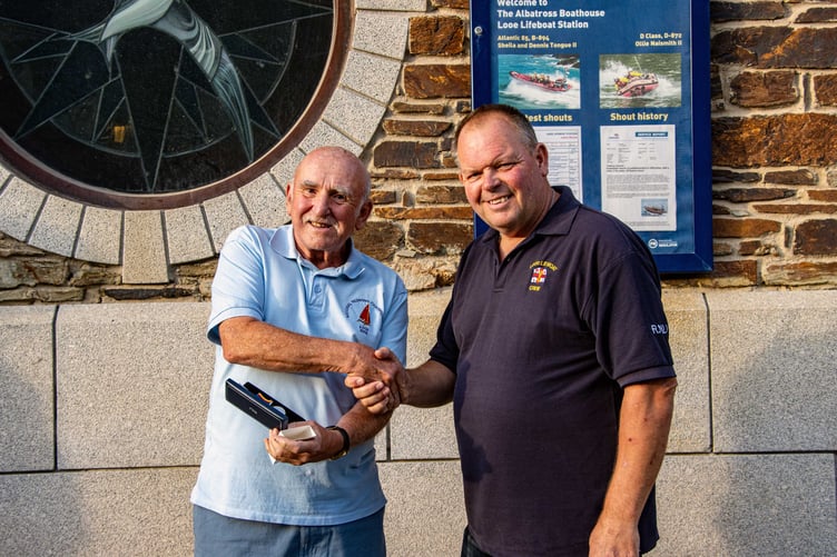 Paul Sedgbeer is presented with his RNLI 20-year service medal by Clive Palfrey