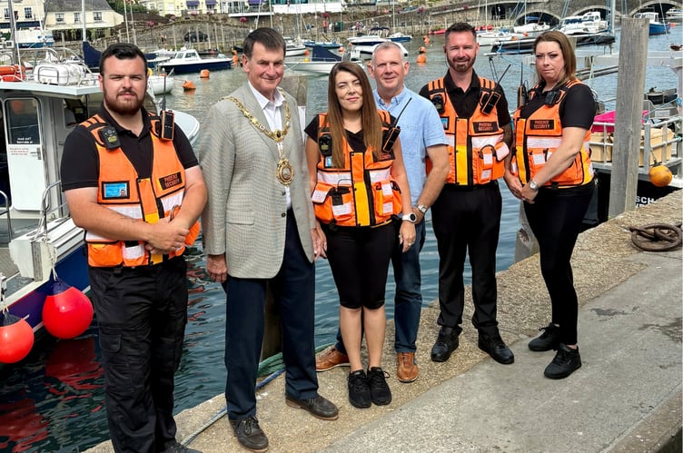 Looe Mayor, Cllr Stephen Remington is pictured alongside Chair of Looe Business Forum, Peter Friend, and members of the Phoenix Security team