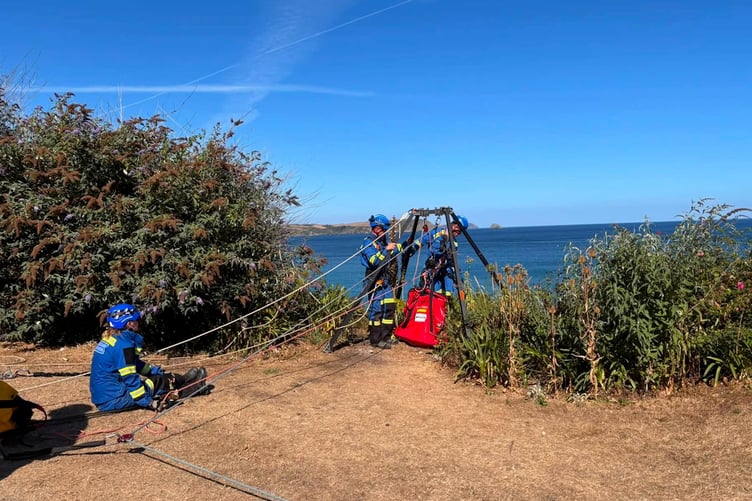 A coastguard armed with a pocketful of treats was lowered down the cliff to the Jack Russell. (Picture: Mevagissey Coastguards)
