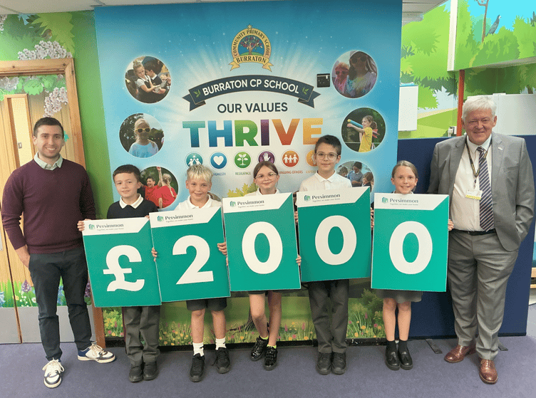 Handing over the funds to pupils from Burraton CP School are Calum Davies. External Affairs Manager – Wales & South West for Persimmon Homes and Cornwall Councillor, Keith Johnson