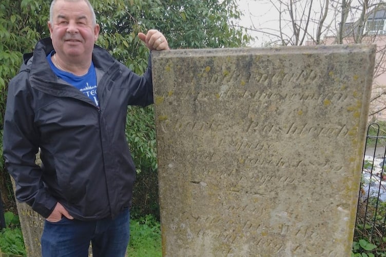 Local historian Lyndon Allen at the grave of Charles Rashleigh.