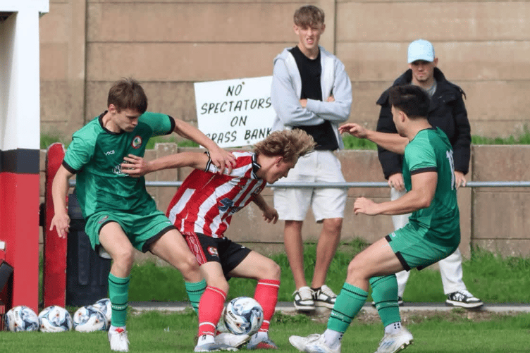 Jack Jefford holds off a Sidmouth defender
