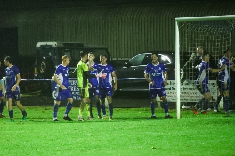 Ollie Chenoweth is congratulated by his team-mates after his match-clinching save.