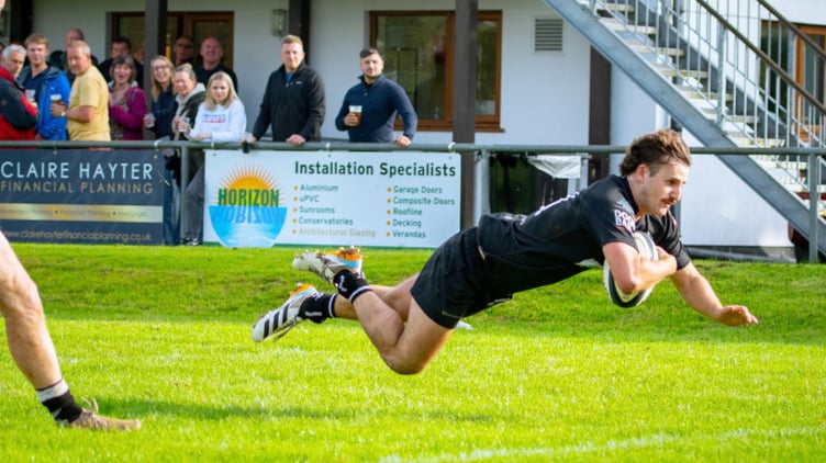 Full-back Ollie Bebbington crosses for Launceston's fifth try which proved decisive following Brixham's late fightback.