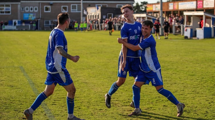 Liskeard Athletic match-winner Harry Probyn (9) is congratulated by fellow attackers Jack Crago and James Lorenz (right).